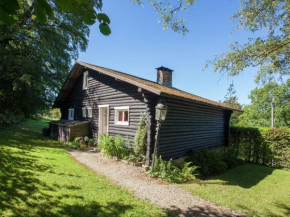 Open wooden chalet built against a hill Francorchamps